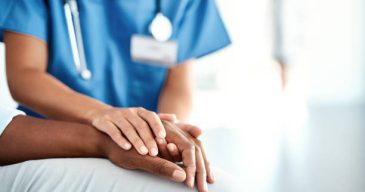 Cropped shot of an unrecognizable female nurse comforting a patient in the hospital