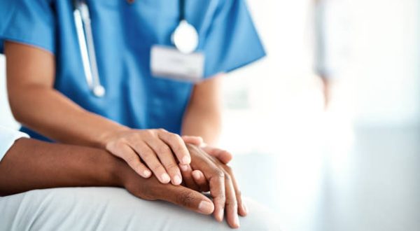 Caring Hands Cropped shot of an unrecognizable female nurse comforting a patient in the hospital